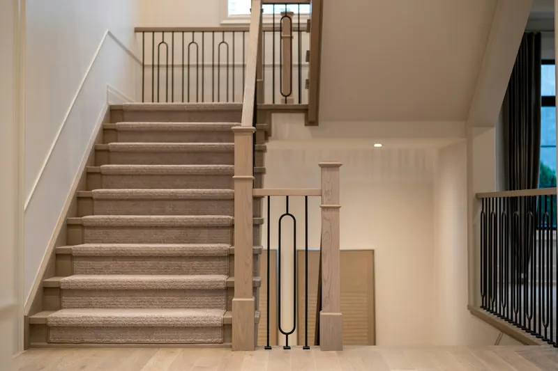 Bright hallway with a carpeted staircase